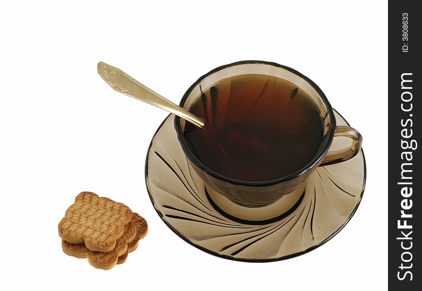 Tea and cookie. Glass transparent cup with tea and cookie. Heat-tolerant utensils