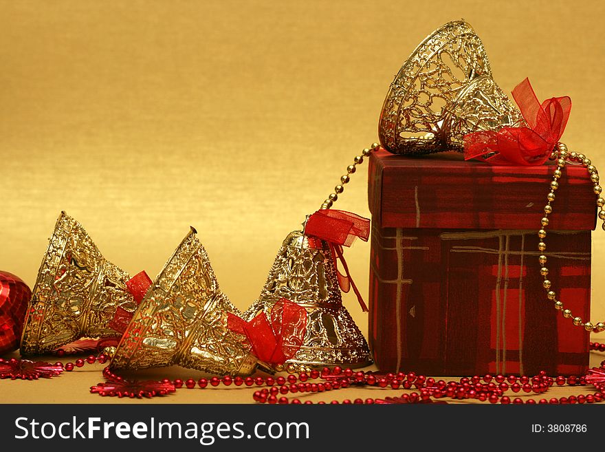 Golden Christmas bells with red gift box