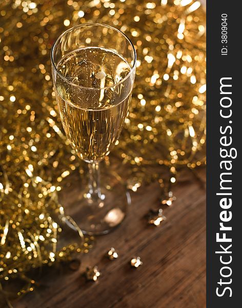 Champagne flute with golden ribbons - shallow dof, focus on the bubbles. Champagne flute with golden ribbons - shallow dof, focus on the bubbles.