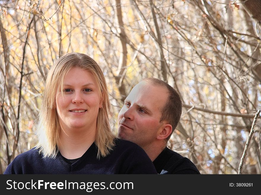 A happy young couple enjoying a forest in Autumn. A happy young couple enjoying a forest in Autumn.