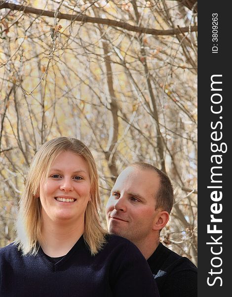 A young couple in love enjoying an Autumn forest. A young couple in love enjoying an Autumn forest.