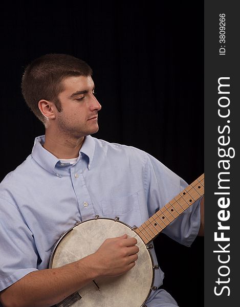 Young man having a good time playing the banjo. Young man having a good time playing the banjo