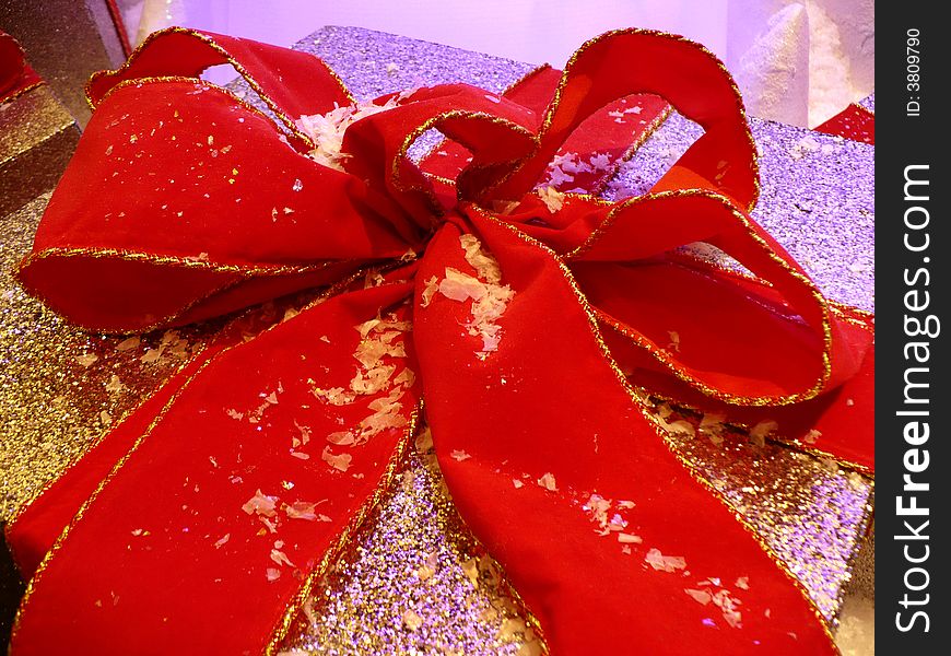 Photo of christmas present tied with a colorful red ribbon. Photo of christmas present tied with a colorful red ribbon.