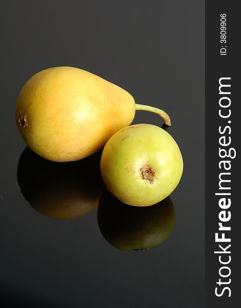A fresh ripe pear showing some color isolated on a black background.