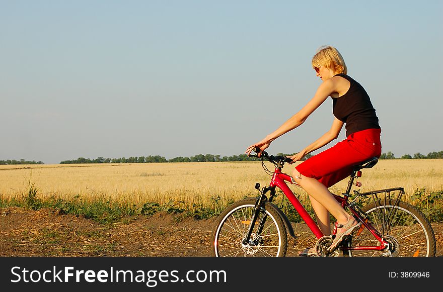 A woman biking at sunset
