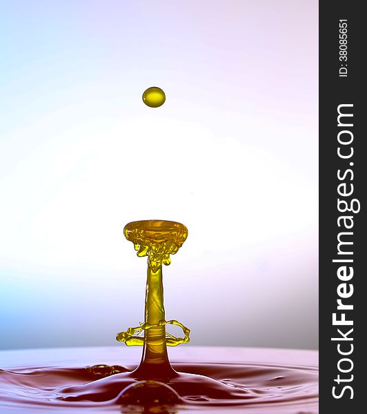 Splashing water drops on color background.Color waterdrops collide each other.