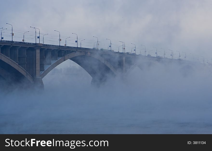 Bridge on river in cold steam