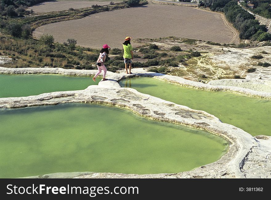 Two tourists visiting famous Pamukkale basins, Turkey.