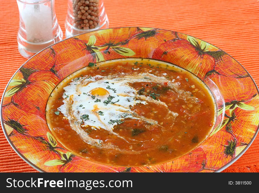 Chunky homemade tomato soup with chopped basil and garlic and a dash of olive oil