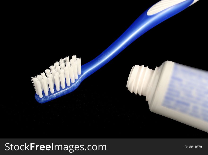 A Blue toothbrush and toothpaste