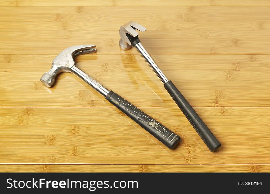 Two hammers on parquet floor