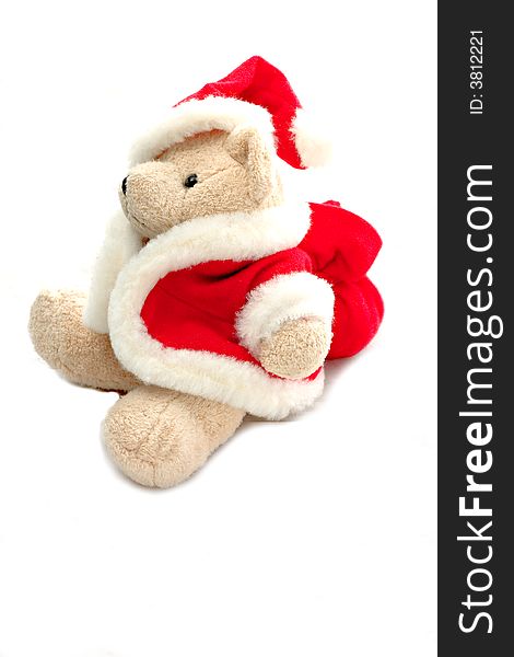 A teddy bear in santa claus dress isolated on white background.