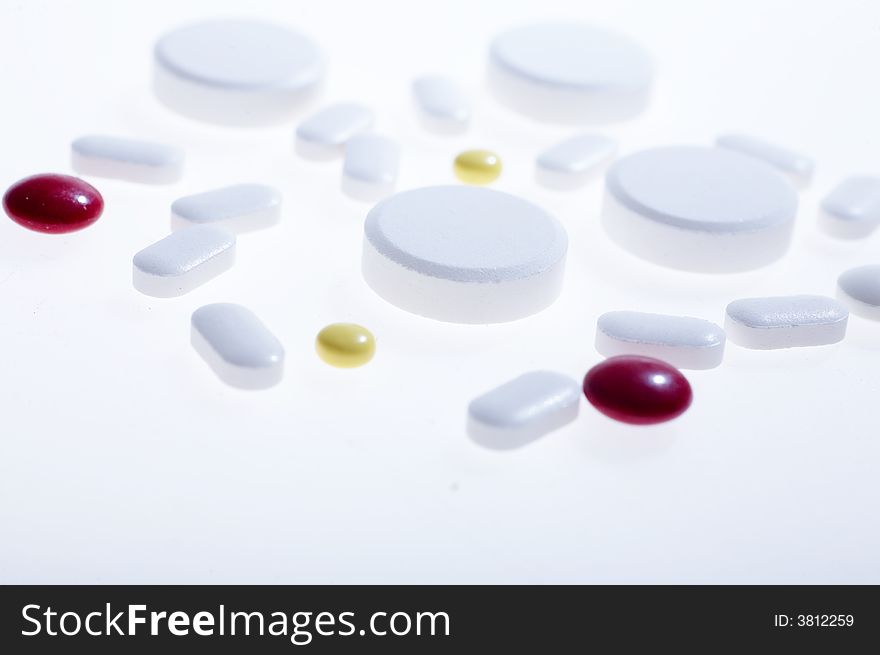 White pills on white background