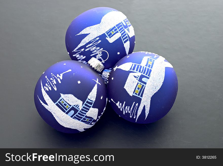 A three decorated christmas balls isolated on black background. A three decorated christmas balls isolated on black background.