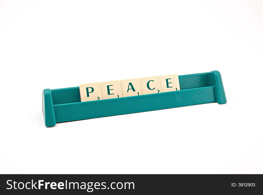 Peace inscription made of plastic letters on white background