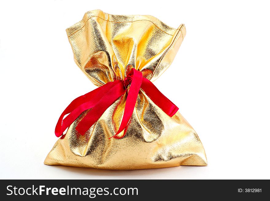 A gift in golden bag with red bow