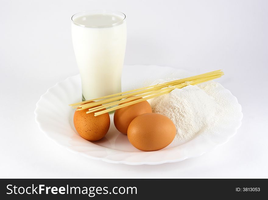 Eggs, milk, spaghetti and flour on white background. Eggs, milk, spaghetti and flour on white background.