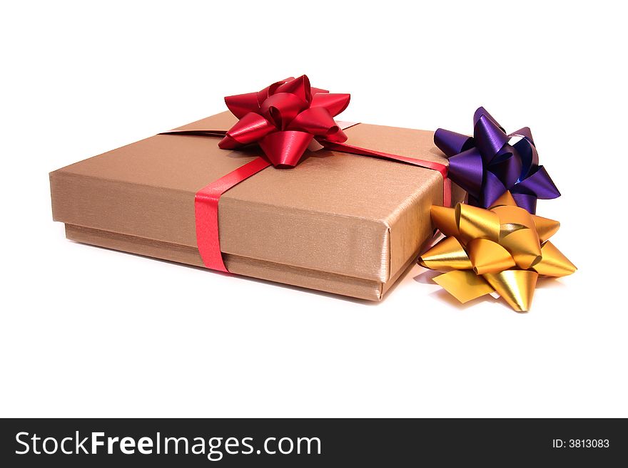 Golden box with colorful ribbons isolated on a white background. Golden box with colorful ribbons isolated on a white background