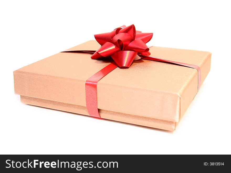 Golden box with a red ribbon isolated on a white background