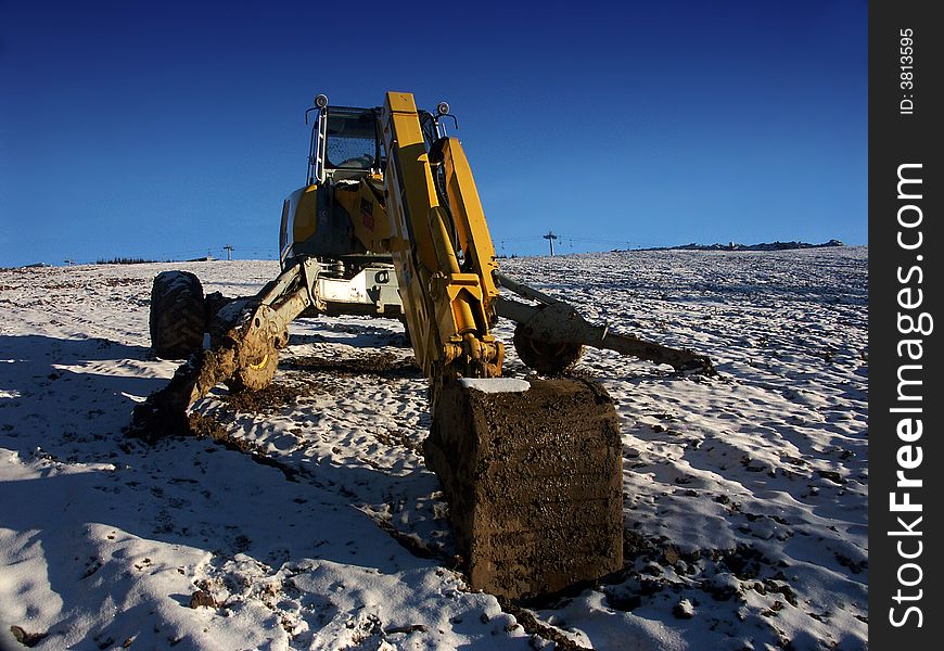 Grab digger in ski centre. Grab digger in ski centre