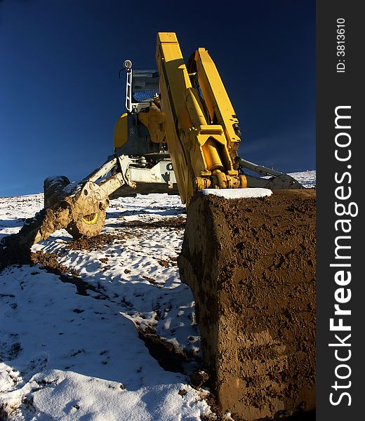 Grab digger in ski centre. Grab digger in ski centre