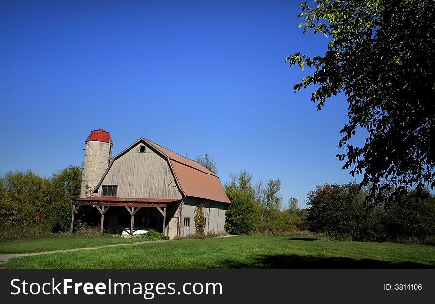 Old barn with bright blue sky background