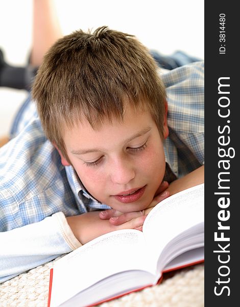 Young Boy learning on the floor