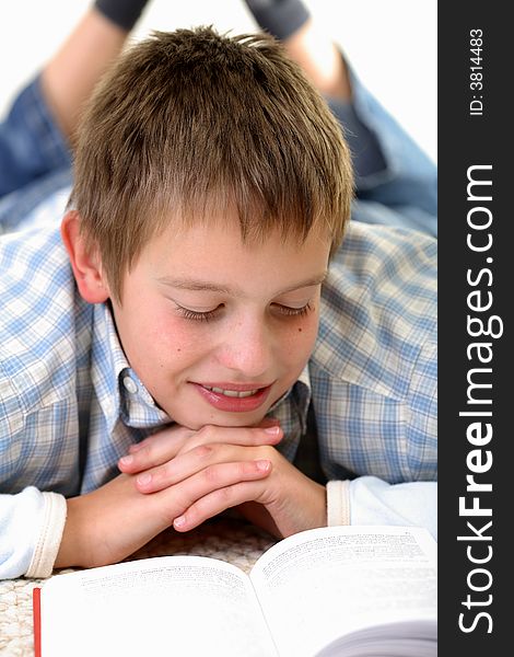 Young Boy learning on the floor