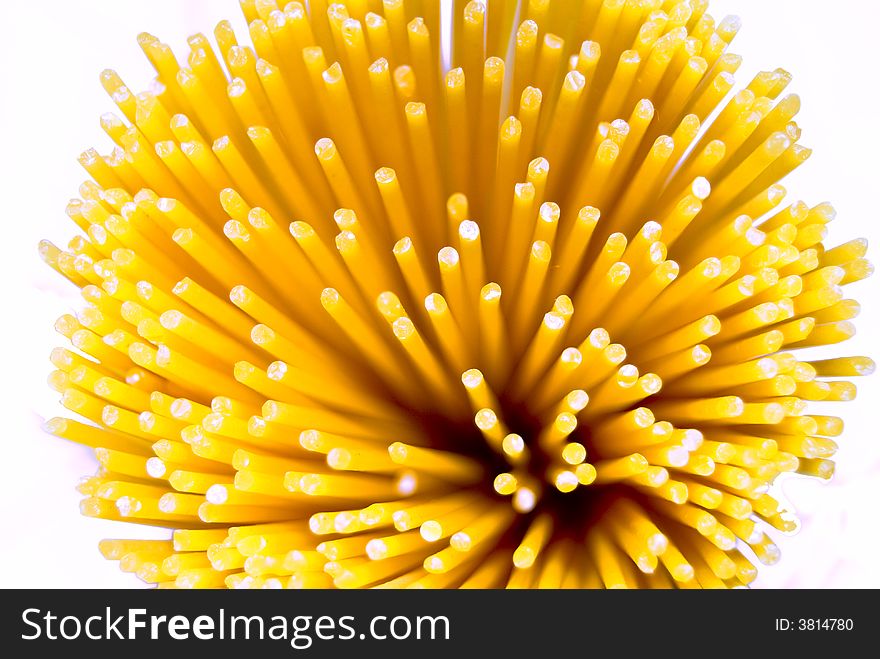 Uncooked spaghetti on white background photographed from above