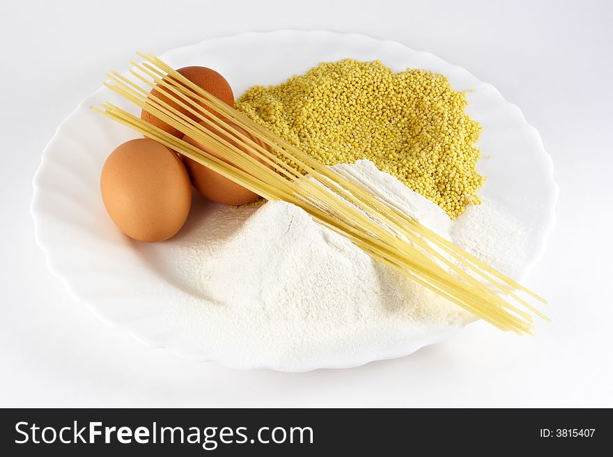 Egg, spaghetti, cereals and flour on white background. Egg, spaghetti, cereals and flour on white background