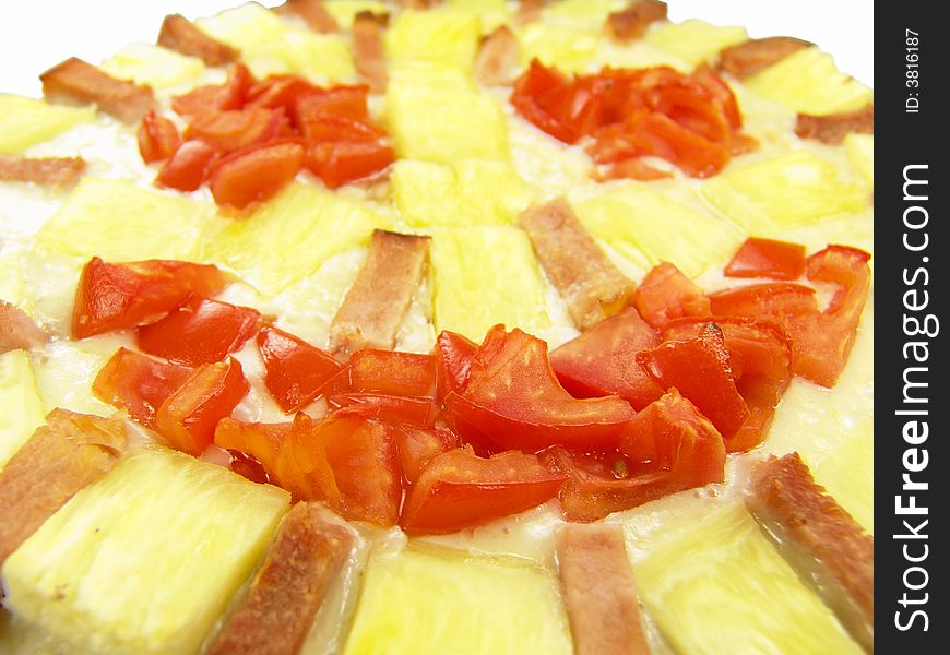 Isolated pizza with tomato, ham and pineapple showing a happy face (close-up). Isolated pizza with tomato, ham and pineapple showing a happy face (close-up)