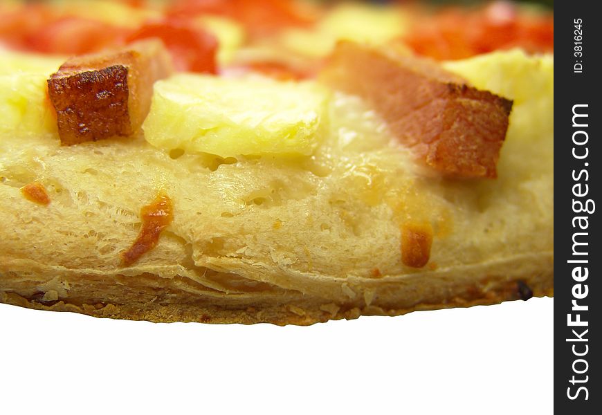 Isolated freshly baked pizza with tomato, ham and pineapple (close-up)