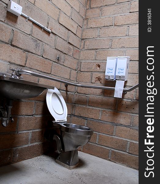 Modern toilet within a mud brick wall in back ground. Modern toilet within a mud brick wall in back ground