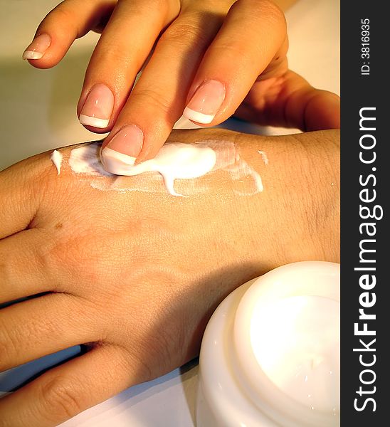 Women with beautiful nails massaging with cream. Women with beautiful nails massaging with cream