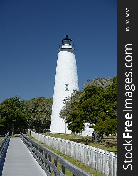 A unique lighthouse has a walkway leading to it