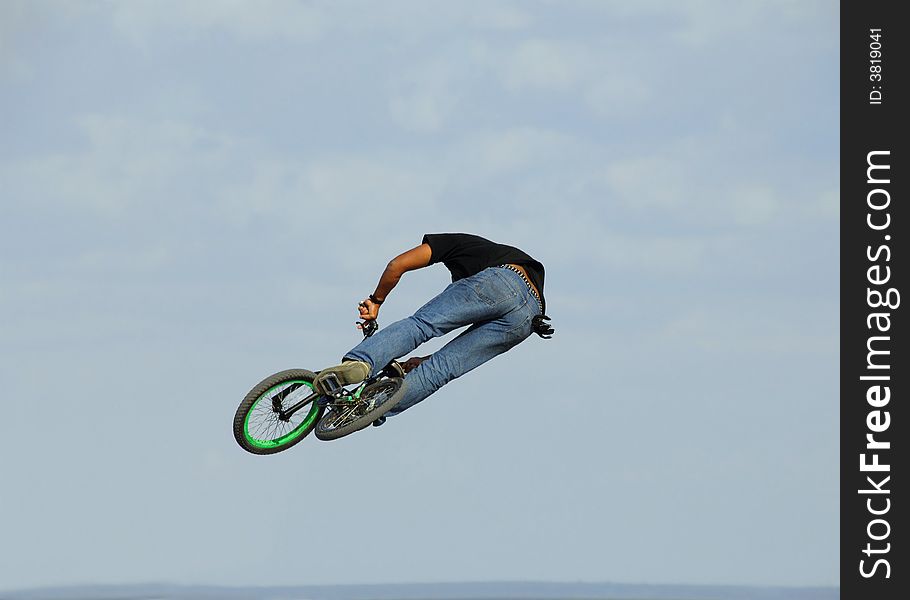 Jump with a mountain bike against sky