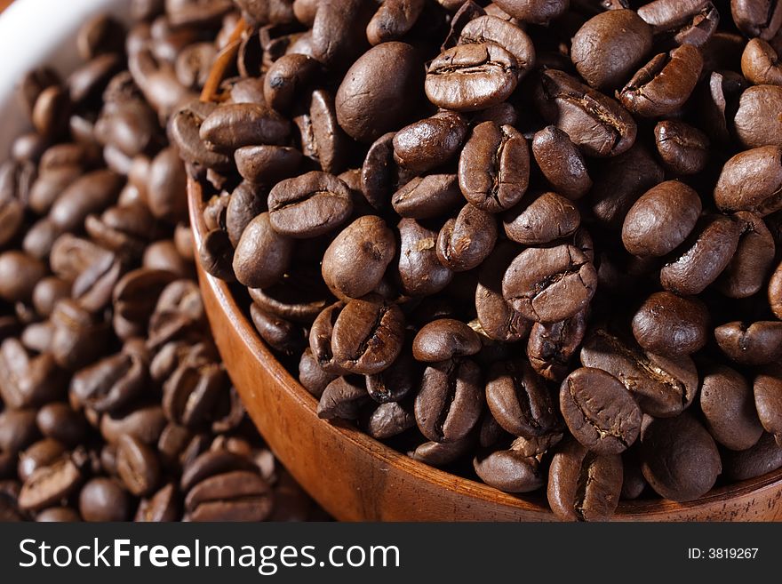 Macro of coffee beans in a bowl. Macro of coffee beans in a bowl.