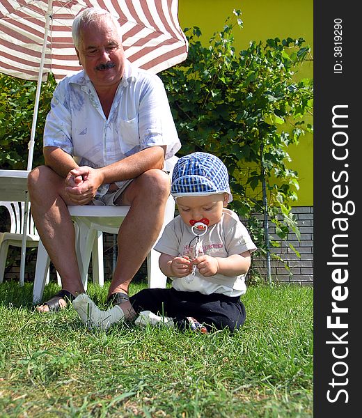 Grandfather and grandsoh on grass