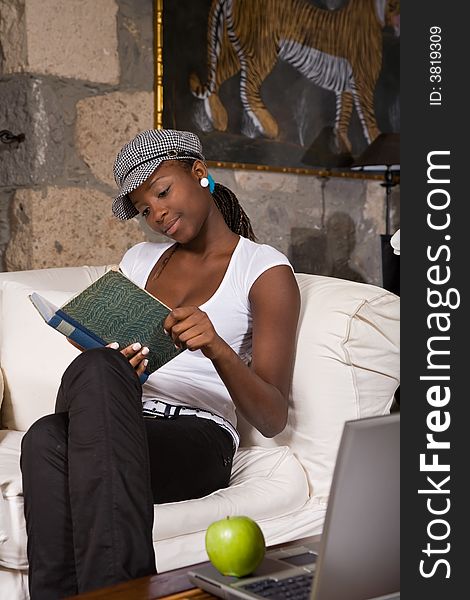 Beautiful young woman reading a book and smiling