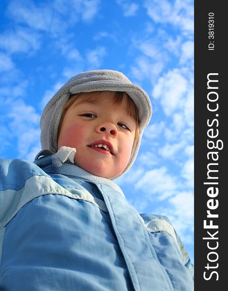 Four year old boy on blue sky in winter time. Four year old boy on blue sky in winter time