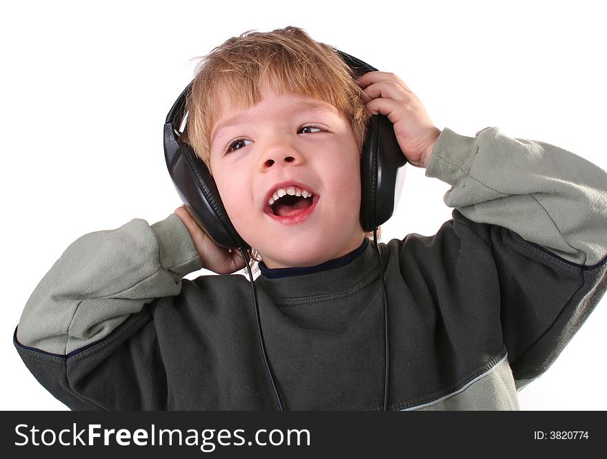 Little boy in headphones listens to music