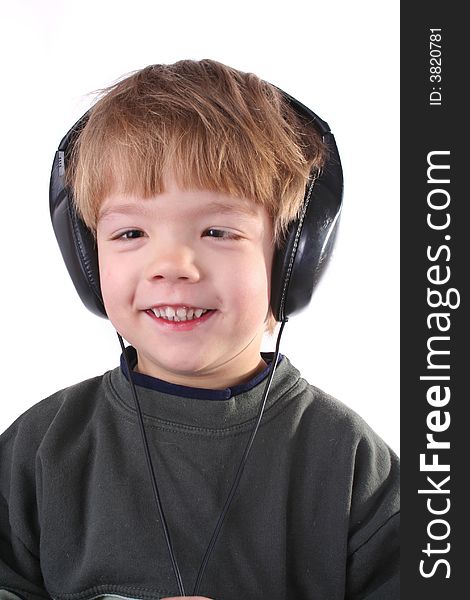 Little boy in headphones listens to music