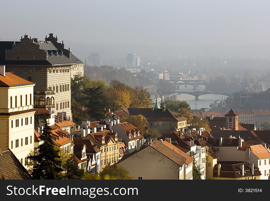 Red roofs of old Prague houses in fall colors with view of Vltava river. Red roofs of old Prague houses in fall colors with view of Vltava river