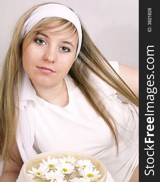 Close up of beautiful face and bowl full of flower. Close up of beautiful face and bowl full of flower