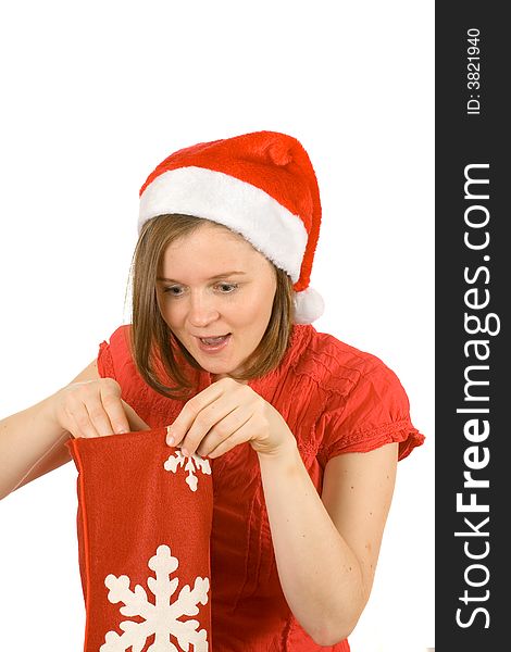 Young girl with cute smile and santa hat looking for her gift in red sock. Young girl with cute smile and santa hat looking for her gift in red sock