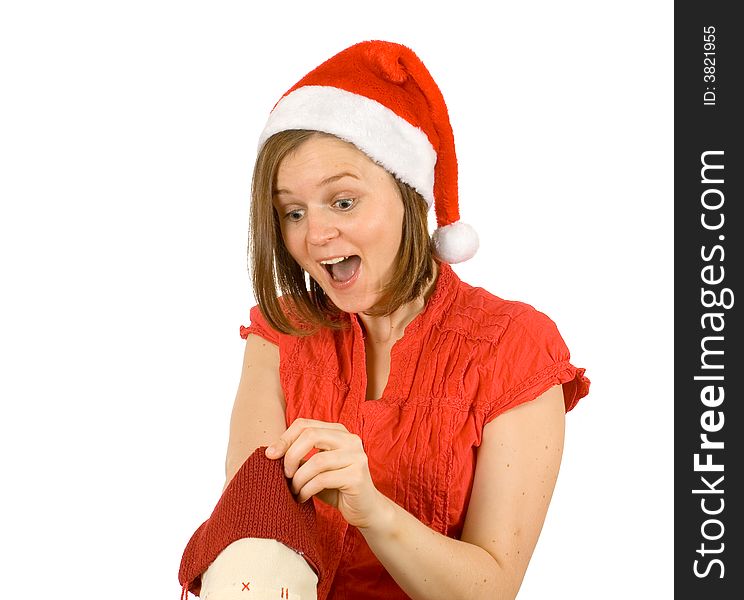 Young girl with cute smile and santa hat looking for her gift in red sock. Young girl with cute smile and santa hat looking for her gift in red sock