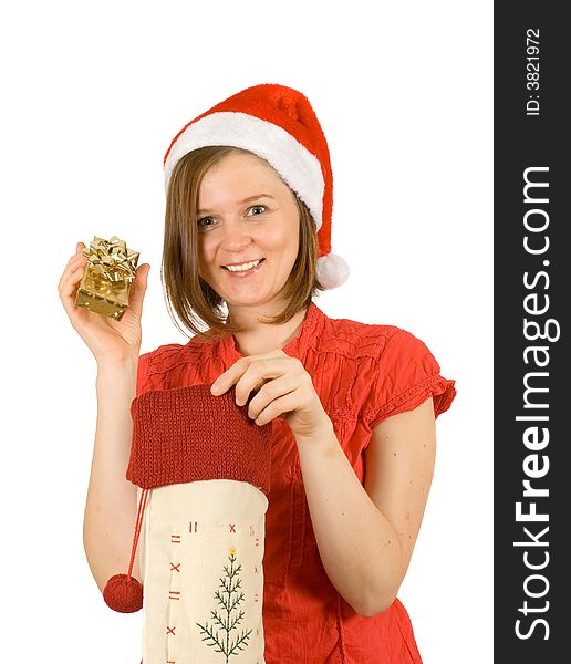 Young girl with cute smile and santa hat showing her golden gift. Young girl with cute smile and santa hat showing her golden gift