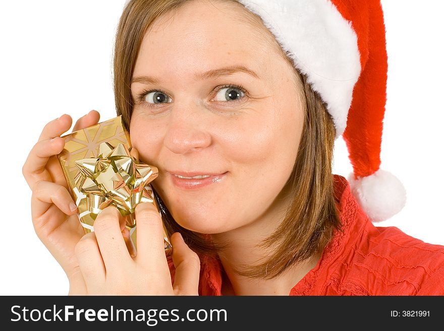 Young girl with cute smile and santa hat, close up of her face with golden wrapped gift. Young girl with cute smile and santa hat, close up of her face with golden wrapped gift