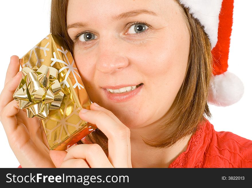 Young girl with cute smile and santa hat, showing her christmas gift. Young girl with cute smile and santa hat, showing her christmas gift