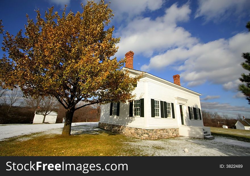 Extreme wide angle shot of white historic house in winter time. Extreme wide angle shot of white historic house in winter time